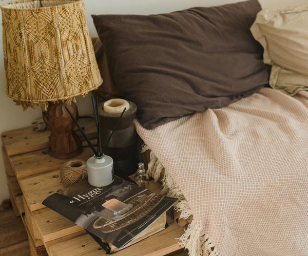 Cozy room with candles, a yoga mat, and soft ambient light.